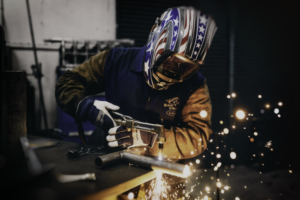 a welder wearing a welding helmet